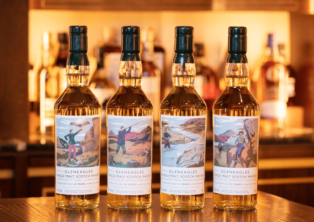 An array of 4 light apricot coloured whisky bottles, detailed with colourful images of the countryside for a fine touch.
